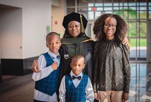 image shows student and family from the MU hooding ceremony